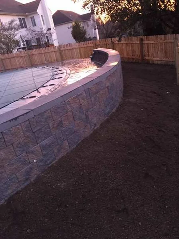 Fence installation along a landscaped border